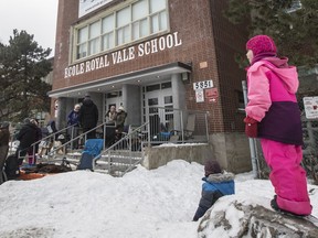 Parents wait in line outside the Royal Vale School to get a chance to register their children at the coveted school in Notre-Dame-de-Grâce Feb. 5, 2017.