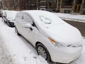 Hearts are carved in the snow on cars parked on Lajoie Ave. in Outremont, Feb. 7, 2017, in response to swastikas that were drawn in the snow on cars in the area. Many residents in the area are Jewish.