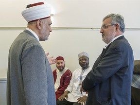 Sheikh Saiid Fawaz, left, Imam Council of Quebec, speaks with Imam Hassan Guillet, right, as Sheikh Fodail Salmoun, left rear, and sheikh Youssef Foufana Tawba, listen in Montreal, Wednesday Feb. 8, 2017, during a press conference to say thank you to Quebecers for their support of the Muslim communities after the Quebec City mosque shooting.