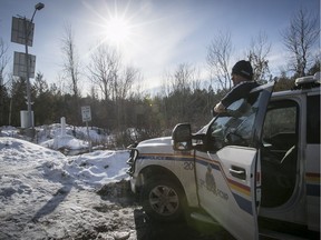 RCMP officer Marcel Pelletier looks over the Canadian - USA border on Roxham road in Saint-Bernard-de-Lacolle, near Hemmingford, Quebec on Thursday February 9, 2017. The road is used by Canadian refugee claimants arriving from the States.