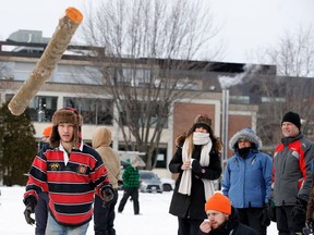 McGill University's Luke Mitchell watches after throwing his last log in the Pulp Throw event during the Intramural-intercollegiate Woodsmen Competition in Montreal on Saturday Jan. 28, 2017.