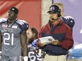 MONTREAL, QUE.: JULY 15, 2016 -- Montreal Alouettes MONTREAL, QUE.: JULY 15, 2016 -- Montreal Alouettes offensive coordinator Anthony Calvillo watches the game from the bench next to linebacker Chris Ackie during Canadian Football League game against the Hamilton Tiger-Cats in Montreal Friday July 15, 2016. (John Mahoney} / MONTREAL GAZETTE) ORG XMIT: 56607 - 2581