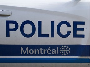 MONTREAL, QUE.: JULY 16, 2014-- A Montreal police car that has been tagged with union stickers protesting proposed changes to the pension funds is parked on de L' Eglise street outside station 15 in Montreal on Wednesday July 16, 2014.  (Allen McInnis / THE GAZETTE)  ORG XMIT: 50470