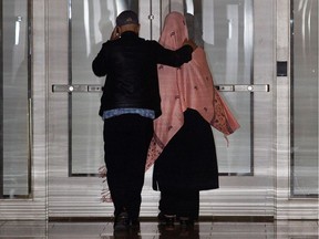 An unidentified couple leave the Montreal Courthouse by the emergency staircase after the bail hearing for for Sabrine Djermane, 19, and El Mahdi Jamali, 18, in Montreal in 2015.