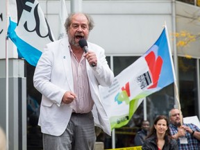 Jeff Begley, president of the Fédération de la santé et des services sociaux, speaks to supporters during a protest against cuts to the health-care system outside the office of Quebec Premier Philippe Couillard in Montreal on Oct. 17, 2014.