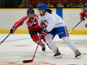 Les Canadiennes' Caroline Ouellette, right, and Noémie Marin and take part in a scrimmage during a team practice on Thursday September 29, 2016.