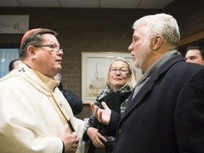 Cardinal Gerald Cyprien Lacroix, left, welcomes Quebec Premier Philippe Couillard at a catholic mass in communion with the victims of the mosque shooting, Tuesday, January 31, 2017 in Quebec City. THE CANADIAN PRESS/Jacques Boissinot