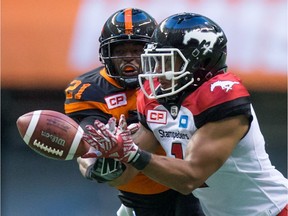 B.C. Lions' Ryan Phillips, back, knocks down a pass intended for Calgary Stampeders' Lemar Durant during the first half of a CFL football game in Vancouver, B.C., on Saturday June 25, 2016.