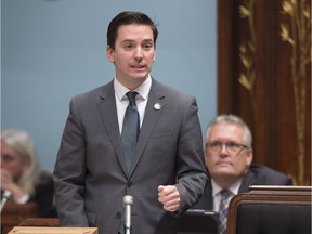 Coalition Avenir Québec MNA Simon Jolin-Barrette questions the government while Liberal government MNA Yves St-Denis looks on at the legislature in Quebec City in February 2017