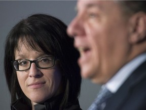 Sonia LeBel looks on as Coalition Avenir Québec leader François Legault speaks during a news conference in Montreal, Feb. 21, 2017, where it was announced that she would become deputy chief of staff for the party.