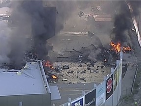 This image made from video shows the site of a plane crash at Essendon Airport in Melbourne, Australia Tuesday, Feb. 21, 2017. An official says a light plane has crashed into a shopping mall in the city of Melbourne.