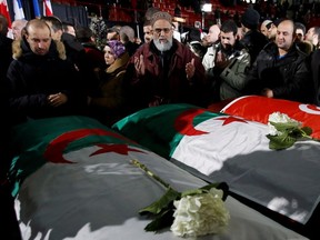 Mourners pray in front of caskets during a funeral ceremony for three of the victims of the deadly shooting at the Centre Culturel Islamique de Québec in Montreal on Feb. 2, 2017.