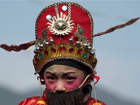 Photo of the day: A boy in traditional clothing waits to be paraded in a festival through the village of Luofang in China's eastern Fujian province. The ceremonies accompanied the Lantern Festival, which officially fell this year on Feb. 11, but whose run-up and aftermath are marked by Hakka observances in Fujian. The Hakka, which means "guest," are Chinese who speak their own eponymous dialect and have a history as wanderers that has given birth to a range of colourful cultural rituals.