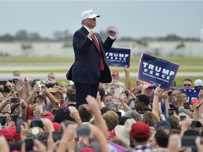 Republican presidential nominee Donald Trump makes his way off stage after a rally at the Lakeland Linder Regional Airport in Lakeland, Florida on October 12, 2016. /