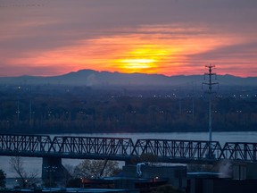 A view of the Victoria Bridge and the St. Lawrence River as the sun rises.