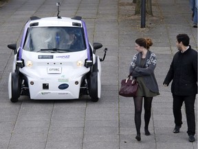 People watch a self-driving vehicle in London in 2016.