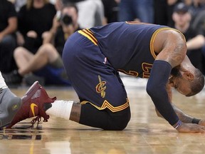 Cleveland Cavaliers forward LeBron James falls to the floor during the second half of an NBA basketball game against the San Antonio Spurs, Monday, March 27, 2017, in San Antonio. (AP Photo/Darren Abate)