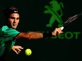 Roger Federer of Switzerland returns a shot against Tomas Berdych of the Czech Republic during Day 11 of the Miami Open at Crandon Park Tennis Center on March 30, 2017 in Key Biscayne, Florida.