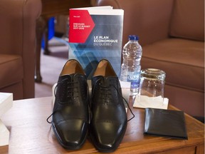 A pair of new shoes and a copy of Finance on the eve of the provincial budget speech on Monday, March 27, 2017 in Quebec City.