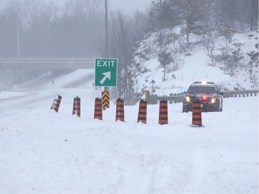 An OPP crusier blocks the ramps for 401 east bound in Landsdowne, Ontario, on Wednesday March 15, 2017. The highway is closed due to a 30 car pile up and a chemical spill linked to a blizzard blowing across eastern Canada and northeastern United States. THE CANADIAN PRESS / Lars Hagberg