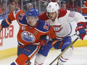 Canadiens' Andrew Shaw and Oilers' Connor McDavid battle for the puck in Edmonton on Sunday, March 12, 2017.