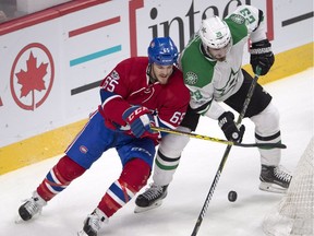 Stars defenceman Greg Pateryn, right, battles Canadiens centre Andrew Shaw for a loose puck during first period Tuesday night at the Bell Centre.