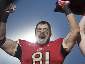 Laval Rouge et Or's Anthony Auclair celebrates winning the Uteck Bowl against Laurier Golden Hawks for the CIS national semifinal Saturday, Nov. 19, 2016, at Laval University in Quebec City.
