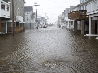 Snow ... and flooding: A Sea Bright N.J. sewage drain is seen intaking large quantities of garbage and water caused by tidal surges associated with the high winds, snow and sleet of the northeastern U.S. storm.