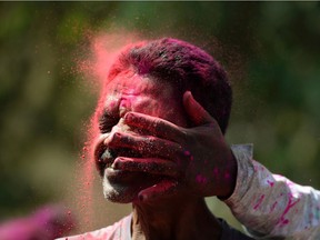 An Indian man is smeared with coloured powder during the Holi celebrations in Mumbai March 13, 2017. Holi, the festival of colours, is a riotous celebration of the coming of spring and falls on the day after full moon in March.