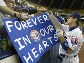 Montreal Expos first baseman Brad Wilkerson signs autographs before the team's final home game against the Florida Marlins in Montreal in 2004.
