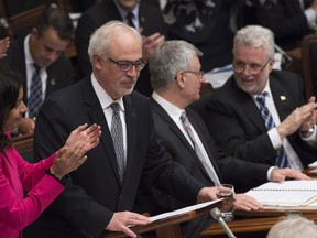 Quebec Finance Minister Carlos Leitao, left, is applauded by Quebec Economy, Science and Innovation Minister Dominique Anglade, left, Quebec government legislature leader Jean-Marc Fournier, centre, Quebec Premier Philippe Couillard, right, and members of the government during the budget speech Tuesday, March 28, 2017 at the legislature in Quebec City.