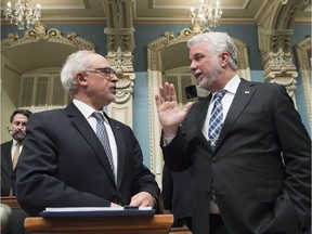 Quebec Finance Minister Carlos Leitao presents the budget speech, Tuesday, March 28, 2017 at the legislature in Quebec City. Quebec Premier Philippe Couillard, right, reads along.