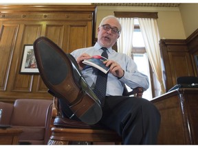 Quebec Finance Minister Carlos Leitão displays his new shoes and his budget speech on Monday, March 27, in Quebec City.