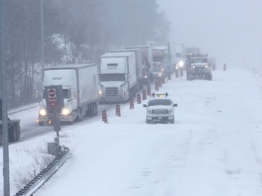 Cars and trucks are being re-routed off 401 Landsdowne, Ontario, on Wednesday March 15, 2017. The highway is closed due to a 30 car pile up and a chemical spill. THE CANADIAN PRESS/Lars Hagberg