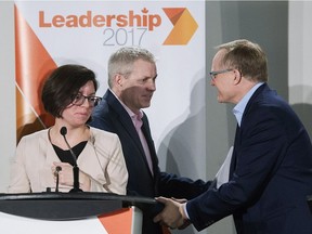 NDP leadership candidate Niki Ashton looks on as fellow candidates Charlie Angus, centre, and Peter Julian shake hands following a leadership debate in Montreal, Sunday, March 26, 2017.