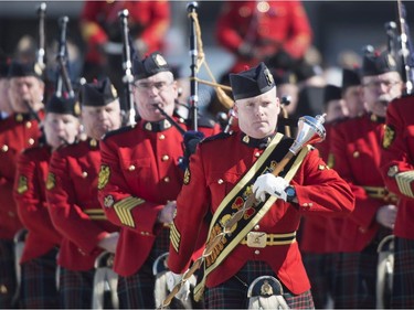 An RCMP piped band leads the procession ahead of the funeral for RCMP Constable Richer Dubuc on the the St-Jean Garrison Military Base in Saint-Jean-sur-Richelieu, Que., on Saturday, March 18, 2017. Constable Dubuc died while on duty on March 6.