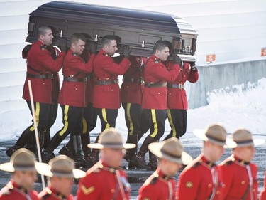 RCMP officers carry the coffin containing the remains of RCMP Constable Richer Dubuc following his funeral on the the St-Jean Garrison Military Base in Saint-Jean-sur-Richelieu, Que., on Saturday, March 18, 2017. Constable Dubuc died while on duty on March 6.