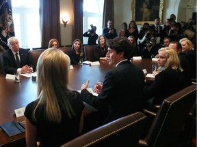 Prime Minister Justin Trudeau speaks as U.S. President Donald Trump listens, during a roundtable discussion on the advancement of women entrepreneurs and business leaders at the White House February 13, 2017 in Washington, D.C.