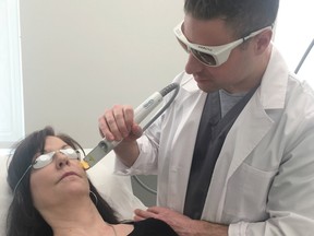 Dr. Roni Munk gives a patient a dermatological treatment.