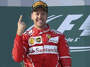 Ferrari driver Sebastian Vettel of Germany celebrates after winning the Australian Formula One Grand Prix in Melbourne, Australia, on Sunday, March 26, 2017.