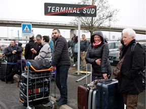 People wait outside the Paris' Orly airport after it was evacuated on March 18, 2017 following the shooting of a man by French security forces.