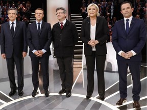 From left to right, Conservative presidential candidate Francois Fillon, Independent centrist presidential candidate Emmanuel Macron, Far-left presidential candidate Jean-Luc Melenchon, Far-right presidential candidate Marine Le Pen and Socialist candidate  Benoit Hamon pose for a group photo prior to a television debate at French TV station TF1 in Aubervilliers, outside Paris, France, Monday, March 20, 2017.