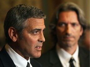 Actor and activist George Clooney with human rights activist John Prendergast.