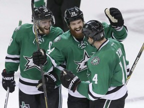 Dallas Stars left wing Jamie Benn (14) celebrates his goal with teammates Alex Goligoski and Jordie Benn (24) during overtime play of an NHL hockey game, against the Vancouver Canucks Thursday, Oct. 29, 2015, in Dallas. When the Dallas Stars visit the Bell Centre on Tuesday, brothers Jamie and Jordie Benn will play against one another for the first time.