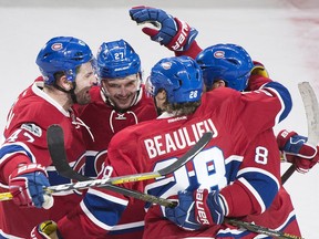 Montreal Canadiens' Jordie Benn (8) celebrates with teammates after scoring against the Ottawa Senators during first- period NHL hockey action in Montreal, Sunday, March 19, 2017.