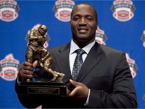 B.C. Lions offensive-tackle Jovan Olafioye holds the trophy for Most Outstanding Offensive lineman trophy as he poses for photographers during the CFL awards show in Toronto Thursday, November 22, 2012. The Montreal Alouettes have acquired all-star international offensive tackle Olafioye from the B.C. Lions for the rights to national offensive-tackle David Foucault.