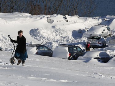On Wednesday morning, March 15, Mariah Cunningham-Kanaus walks home after digging her car out in a parking area on the eastern promenade in Portland, Maine.