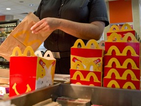 A worker packs happy meals at a McDonald's restaurant.