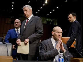 Valeant's outgoing CEO, J. Michael Pearson, standing, and former chief financial officer Howard Schiller, right, arrive on Capitol Hill in Washington, April 27, 2016, to testify before the Senate Special Committee on Aging hearing on drastic price hikes by Valeant and a handful of other drugmakers.