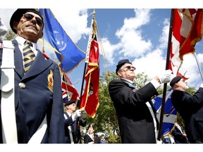 Members of the 234 Legion hoist their flags aloft. Veterans and members of several military units gather at the Dorval Cenotaph to celebrate the anniversary of the Battle of Britain in September 2007.